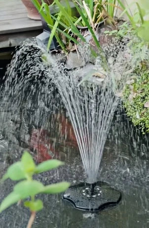 POPOSOAP floating fountain creating water movement and LED light effects in a garden pond