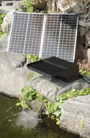 POPOSOAP solar waterfall pump kit creating a cascading pond waterfall